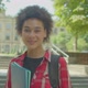 Portrait of Charming Black Female Student Looking with Cheerful Smile Outdoor - VideoHive Item for Sale