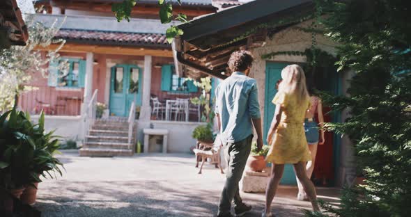 Friends walk through doorway alt