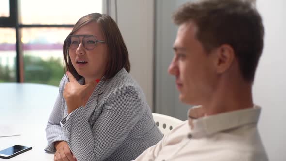 Tracking Shot of Happy Asian Business Woman and Caucasian Man Sitting Office Table Discussing Ideas alt