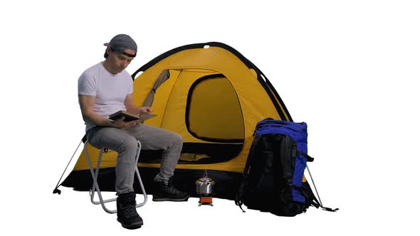 Camper Sitting and Reading Book Near Tent, Alpha Channel In