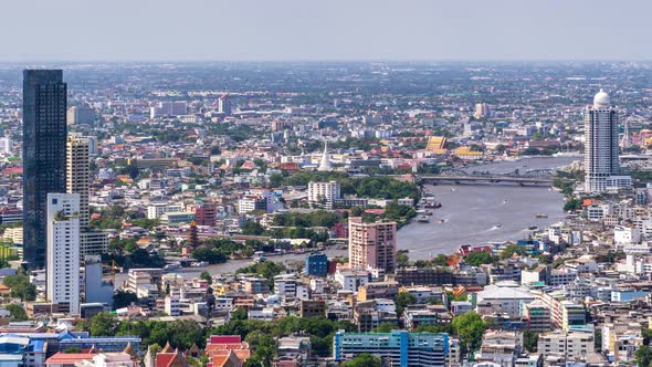 Bangkok city above old town area and Chao Phraya River, with water traffic; zoom out – Time Lapse