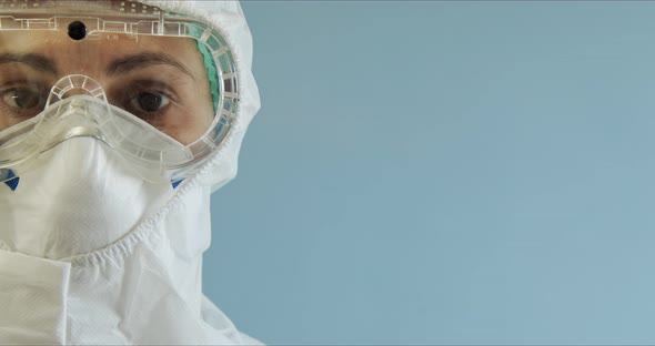 Doctor in Protective Suit with Face Mask Eyeglasses and Gloves Portrait