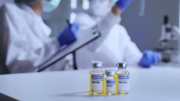 The Coronavirus or COVID vaccine researched by pharmaceutical bio research in laboratory room. alt