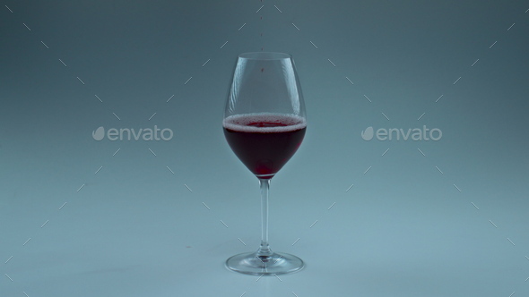 Circle shaped wine drops falling into glass closeup. Stock Photo by  stockbusters