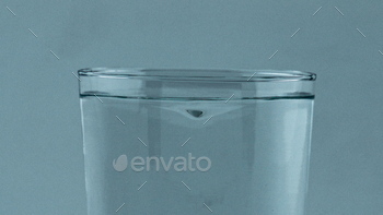 Closeup aqua tornado inside transparent glass. Beverage whirlpool clean vessel