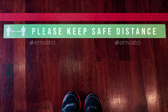 Please keep safe distance sign on the floor during coronavirus outbreak - social distancing concept