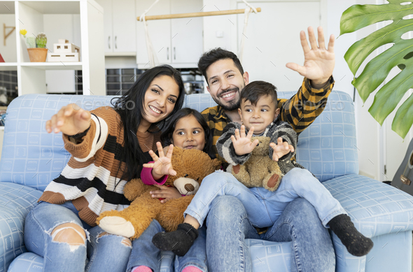 Happy Indian couple and their young children Stock Photo by ...