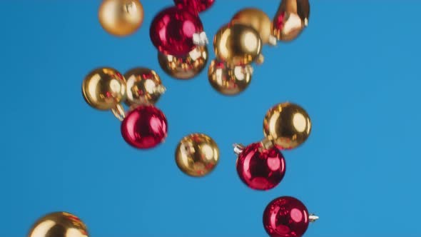 Flying Christmas Balls Against Blue Background