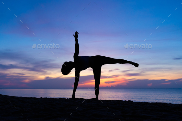 Beautiful Girl Wearing Shorts And Sports Bra In Yoga Pose With Waves  Crashing Over Her Legs On Beach Stock Photo, Picture and Royalty Free  Image. Image 98130965.
