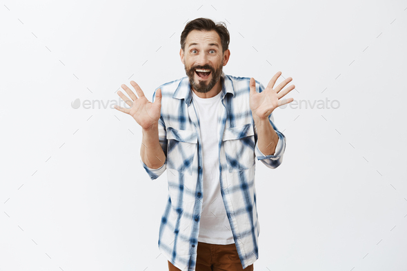 Jazz hands make day happier. Portrait of charming excited joyful european male with beard and mousta