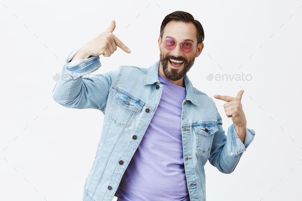 Look at me, I am cool dad. Portrait of handsome adult bearded male in trendy sunglasses and denim ja