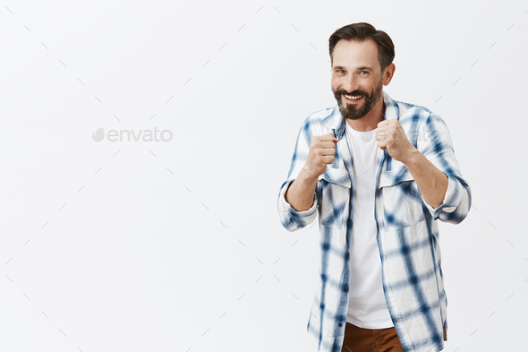Come on attack. Portrait of handsome friendly and playful european man with beard, standing in boxer