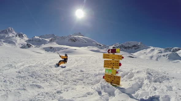 A young man snow kiting on a snowboard. alt