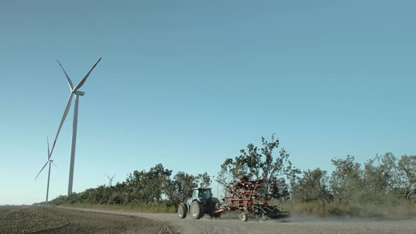 Tractor with Seeder in Front of the Wind Turbine