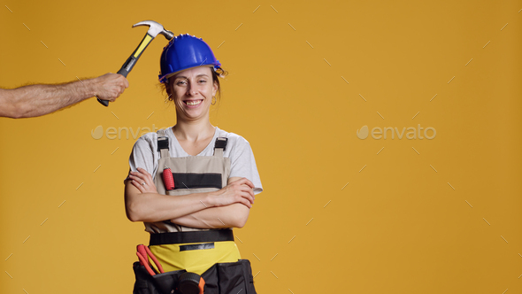 Portrait of female builder being hit in head and feeling dizzy