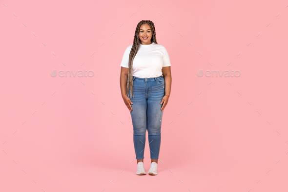 Happy Black Plus Size Female Model Posing Over Pink Background