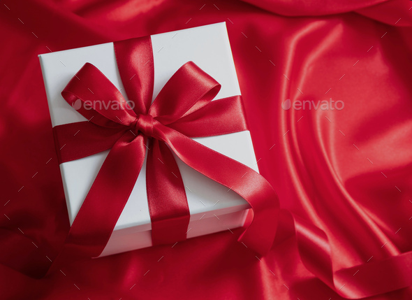 Christmas gift box and red silk ribbon on white background, top view. Stock  Photo by rawf8