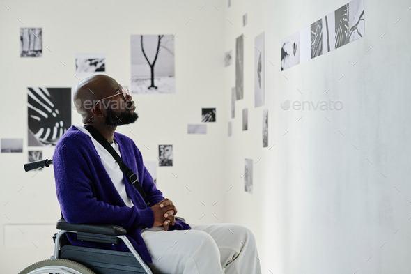 Man with disability visiting exhibition at gallery