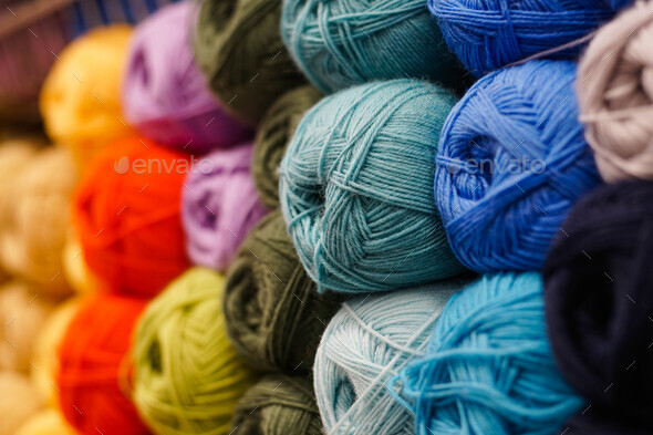 Many colorful yarn for handmade knitting in a needlework shop. Stock Photo  by Glebcallfives