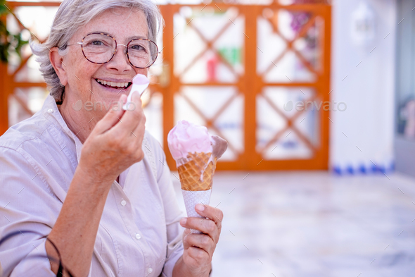 Beautiful Happy Senior Woman Sitting Outdoors On A Bench Eating A