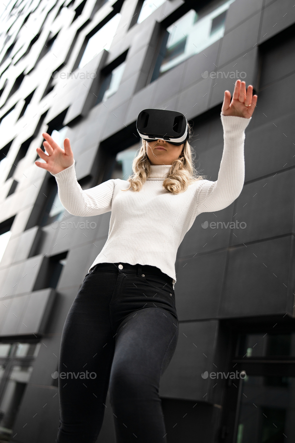 Woman Gesturing Using Virtual Reality Glasses In Metaverse Business - Stock Photo - Images