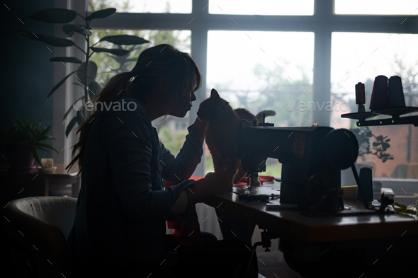 Dressmaker With Sewing Machine In Her Studio Stock Photo, Picture