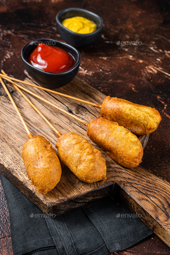 Traditional American street junk food Deep fried corn dogs with mustard