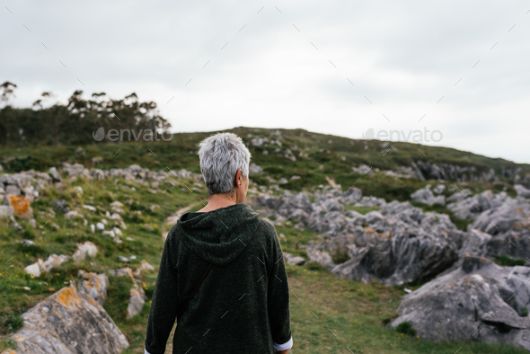 older woman with gray hair strolling to stay active