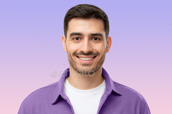 Headshot portrait of smiling young man isolated on purple
