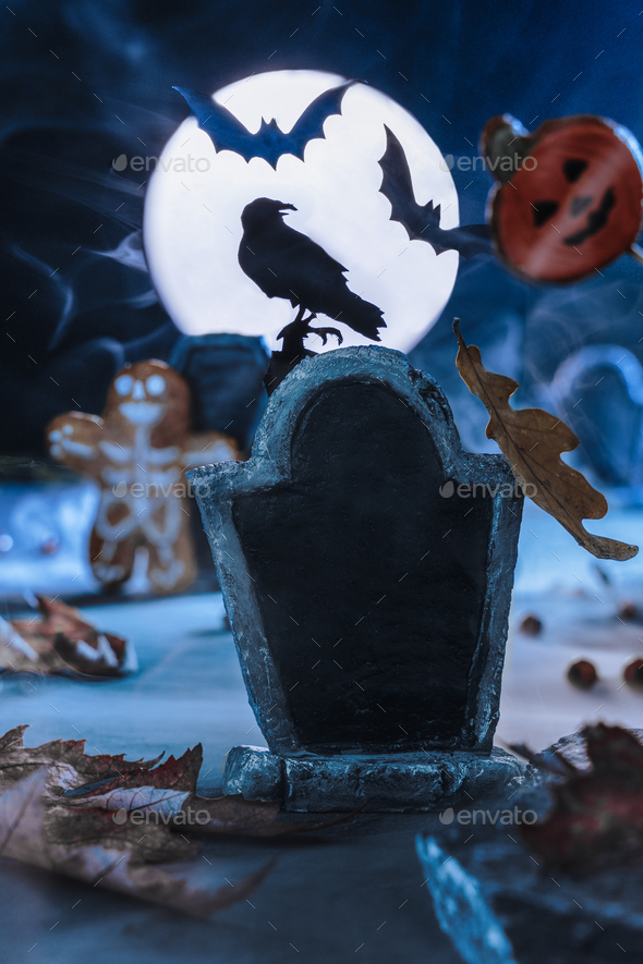 Scary cemetery in fog at night by the light of the moon, crows, bats. Halloween background.