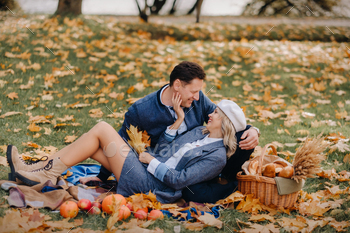 Happy couple enjoying golden autumn spring season in the park