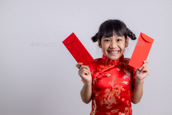 Chinese baby girl traditional dressing up with a FU means lucky red envelope - Stock Photo - Images