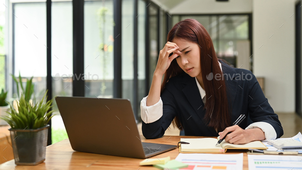 Tired female employee woman having headache, stress, hard work and insufficient rest. - Stock Photo - Images