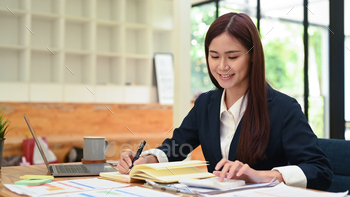 Smiling female accountant in formal wears using calculator and working with financial statistics.