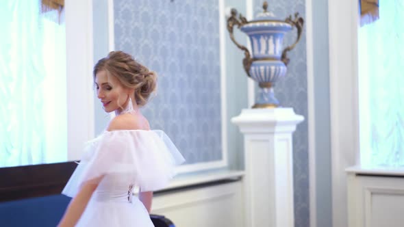 Blonde Bride Is Spinning in a Wedding Dress in a Chic Room