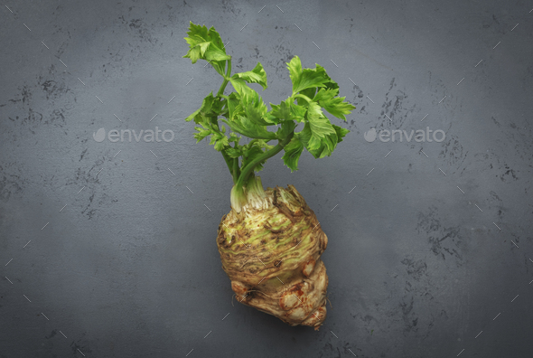 Fresh root celery with green stems Stock Photo by Olga_Kochina