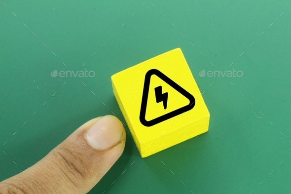a yellow cube with an electrical hazard sign concept