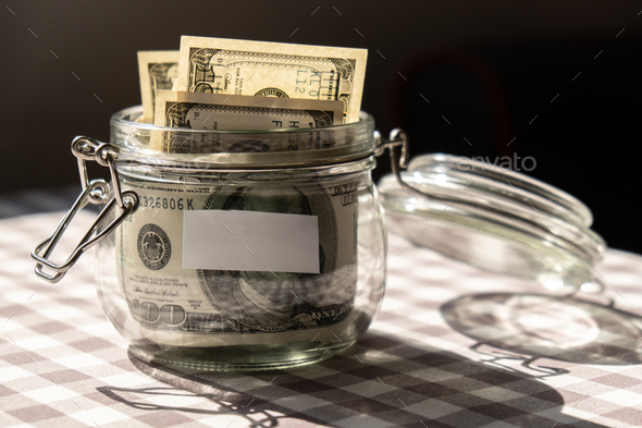 Dollar banknote saving money in glass jar. Consumption and economy Collecting money. Tips. Business