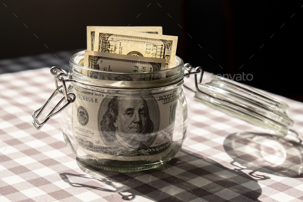 Dollar banknote saving money in glass jar. Consumption and economy Collecting money. Tips. Business