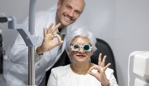Ophthalmologist measures eyesight for an elderly woman.