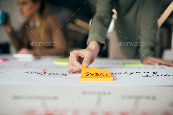 Close-up of entrepreneur making mind map while working on new business project in the office.