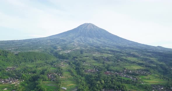 Drone: Rural aerial view of Central Java, Indonesia With Mount Sumbing in background - Beautiful sce alt