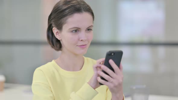 Young Woman Using Smartphone Browsing Internet alt