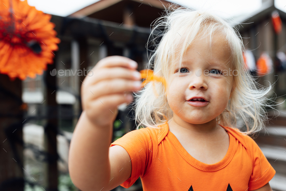 Lifestyle portrait of Happy caucasian baby girl with blonde hair in ...