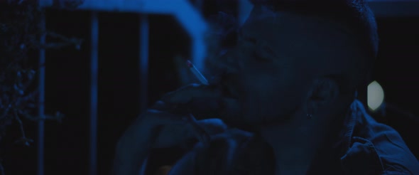 An adult soldier man smoking a cigarette outside at night, dealing with anxiety and depression. alt