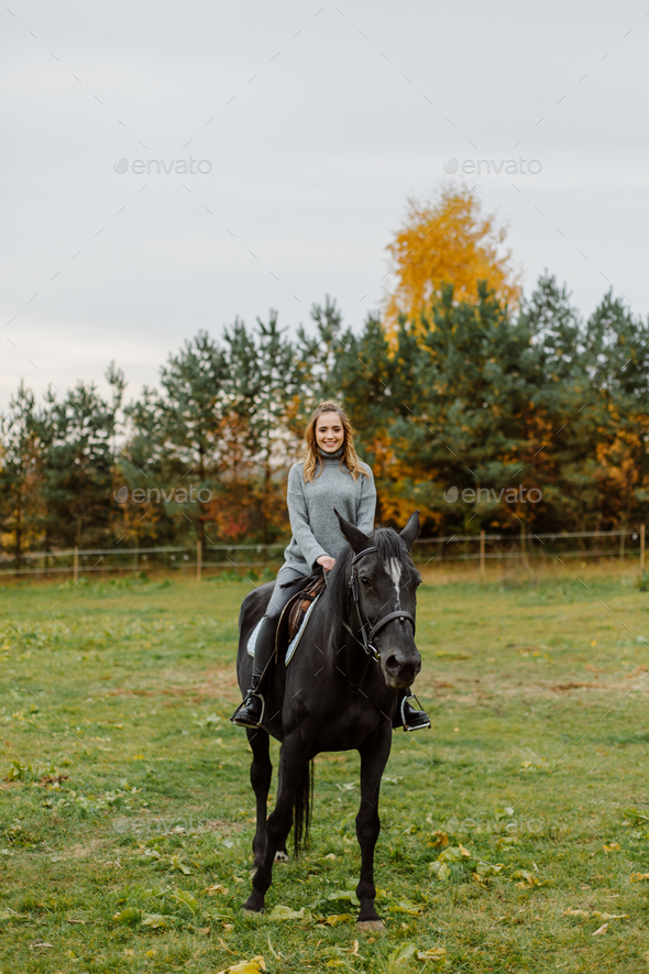 Woman on a horse at rancho. Horse riding, hobby time. Concept of animals and human - Stock Photo - Images