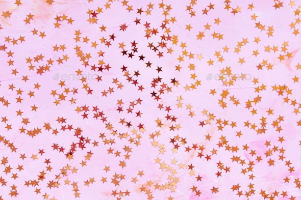 Rose gold foil confetti stars on pink background