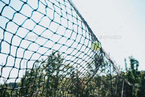 Time stop image of a tennis ball crashing against the court net with copy space, sport concept