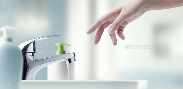 Woman washing hands in the bathroom - Stock Photo - Images