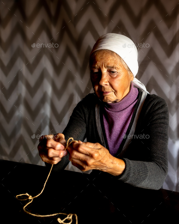 Elderly dame. Hands of old woman with polyarthritis disease. Canvas strings on fingers of elderly